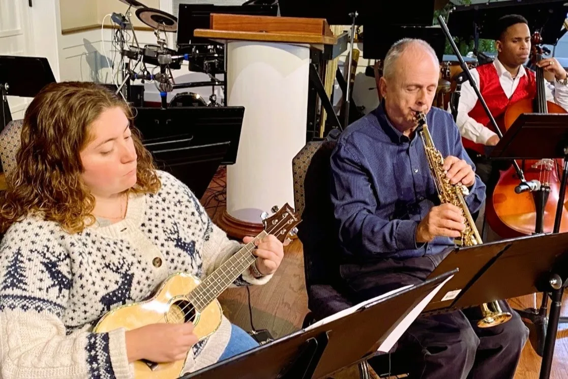 Musicians sharing laughter during rehearsal
